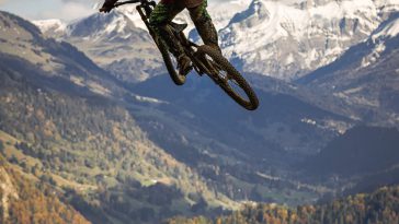 man in red jacket riding motocross dirt bike