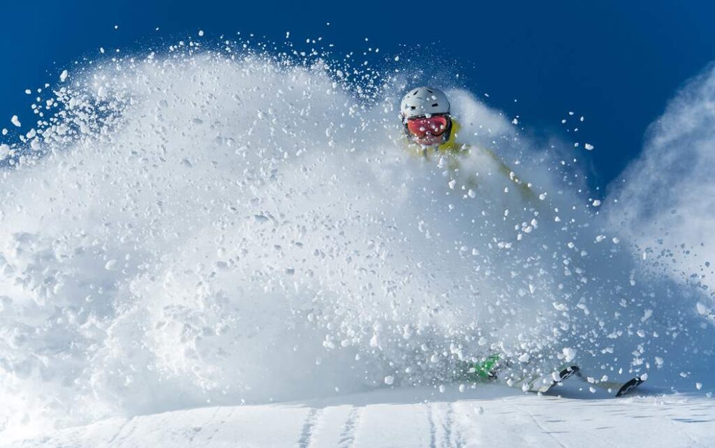 skier pounding through powder